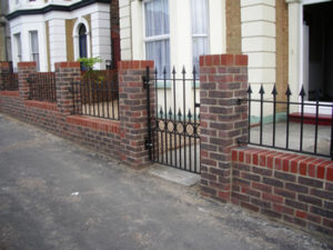 New brick wall with iron railings 1
